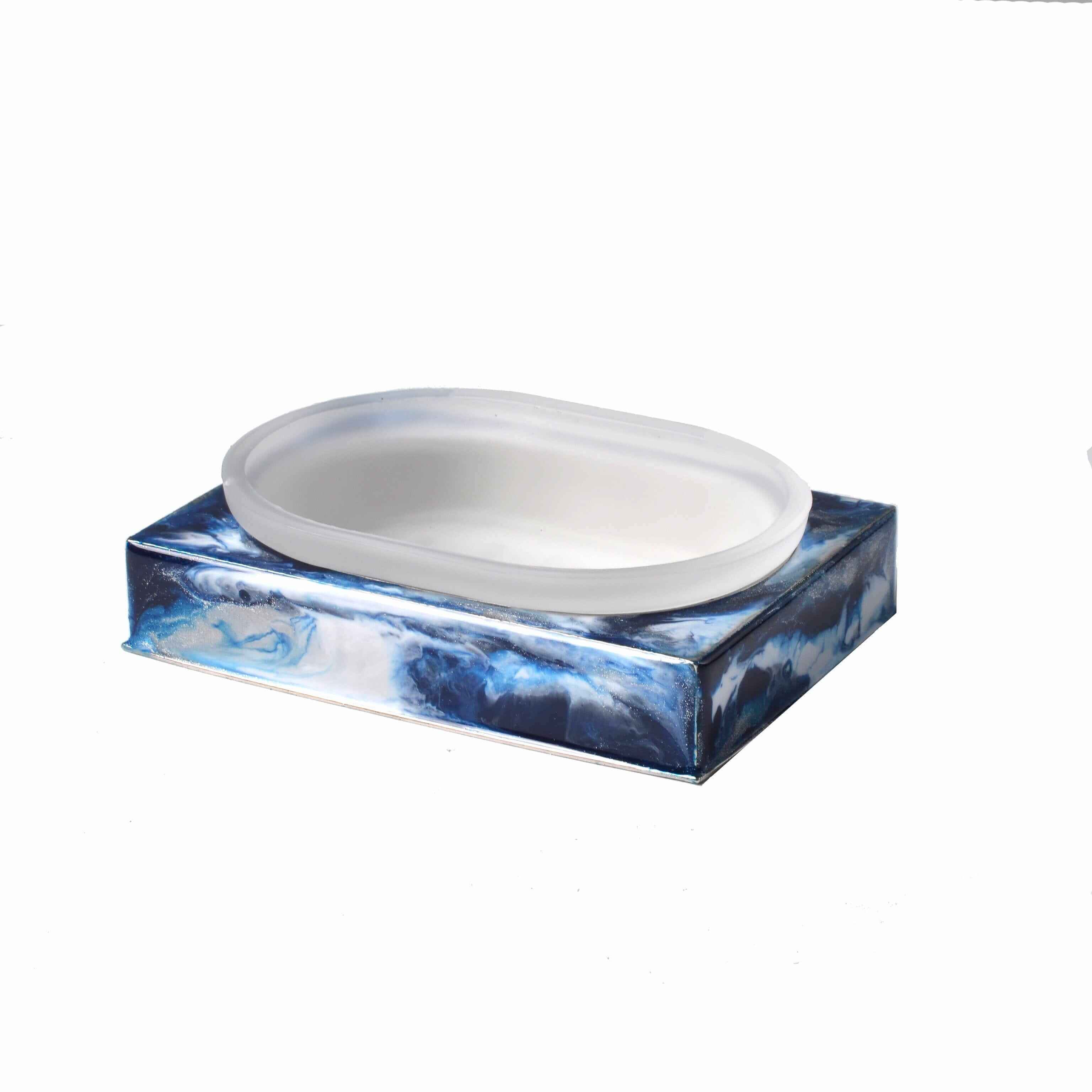 Glass soapdish sitting in metal hand enameled base. Tints of blue.,