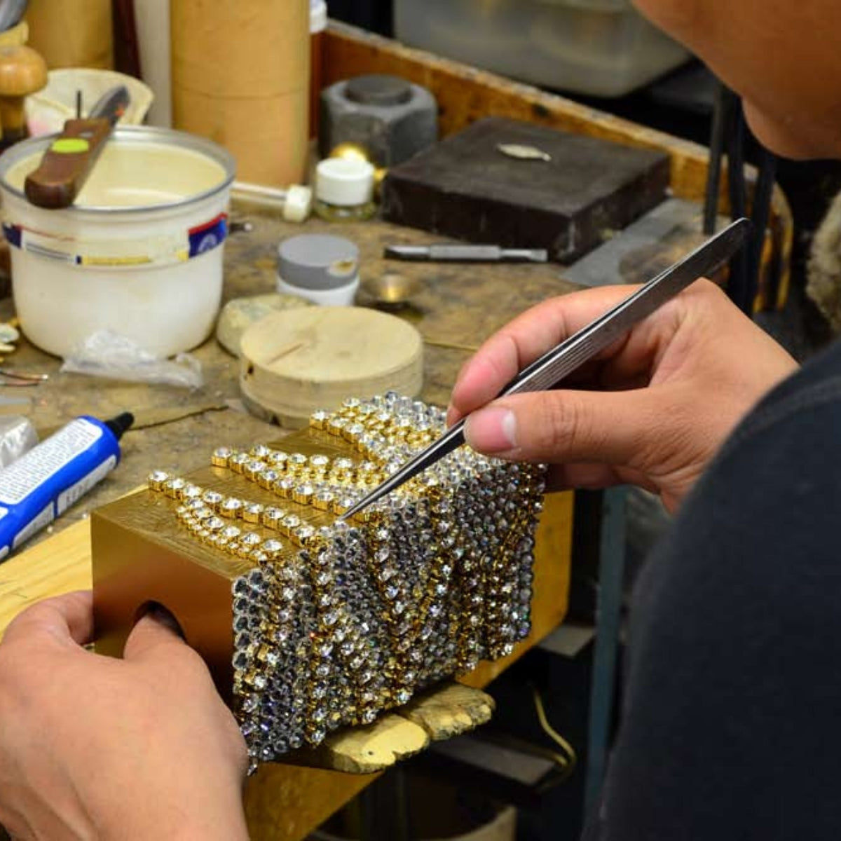 Applying embellishment to a lotion pump.