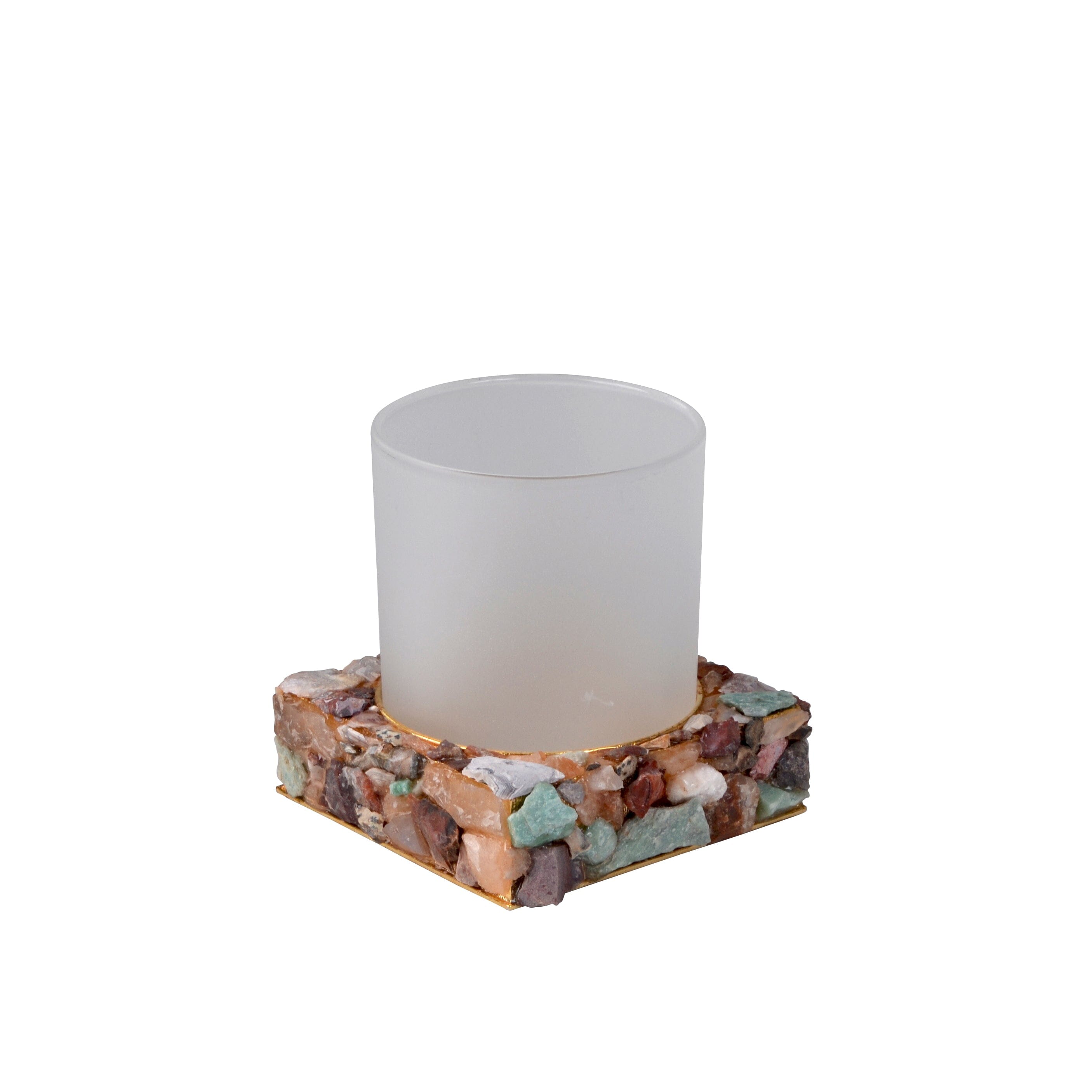 Glass tumbler with assorted, unpolished, semi-precious gemstones.