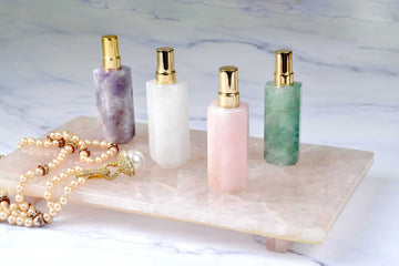 4 Gemstone atomizers in assorted colors: amethyst, white quartz, rose quartz and flourite.