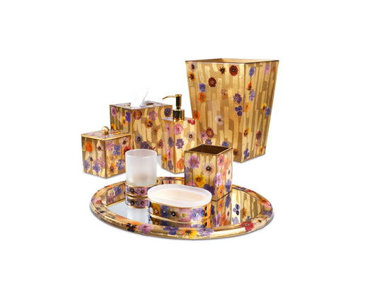 A decorative bath accessory set hand enameled with wild flowers on gold.