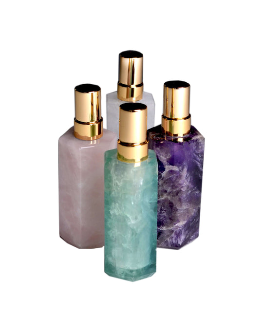 4 gemstone atomizers with golden tops in assorted colors; amethyst, flourite, rose quartz and white quartz