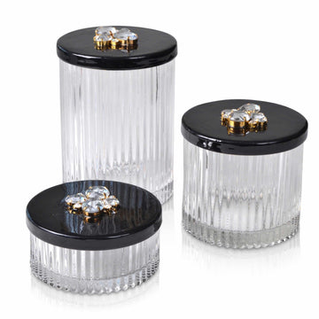 Glass jars with hand enameled lids embellised with crystals.