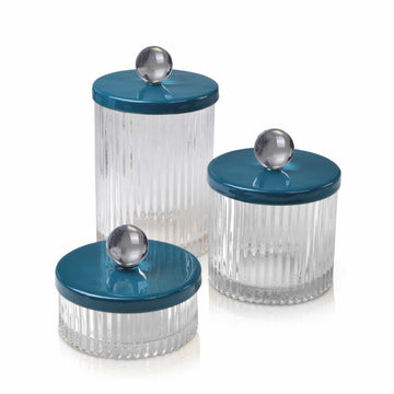Glass jars with hand enameld blue lids adorned with lucite balls